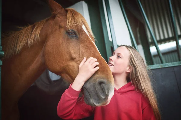 Horses before anything else. Shot of a teenage girl bonding with her horse. — Stock Photo, Image