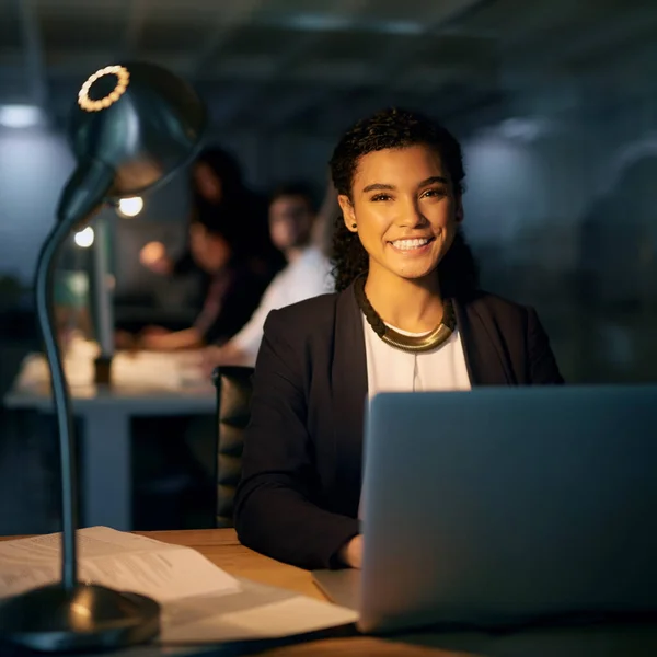 Theres no way Im missing this deadline. Portrait of a young businesswoman using her laptop while working overtime in the office. — Stock Photo, Image