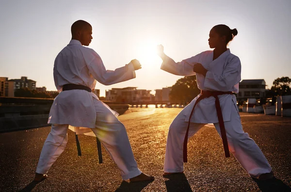 Ready...fight. Two sportspeople facing off and practicing their karate while wearing gi. — Stock Photo, Image