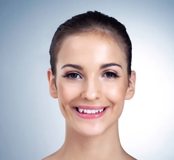 Shes simply beautiful. Studio portrait of a beautiful young model posing against a blue background. Stock Photo