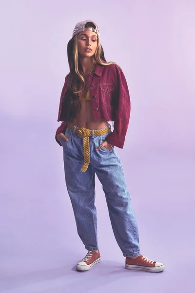Fashion makes me feel some type of way. Studio shot of a beautiful young woman posing against a purple background. — Photo