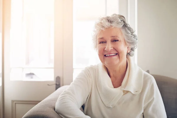 Older but wiser and happier than ever before. Portrait of a senior woman relaxing at home. — Stock Photo, Image