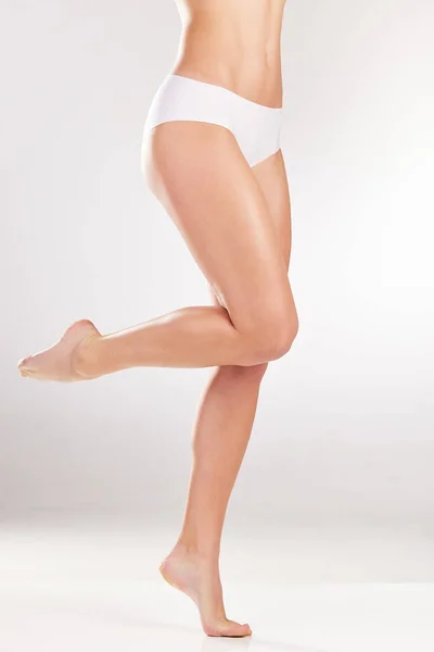 Las piernas perfectas para cualquier atuendo. Estudio de una joven irreconocible posando en ropa interior sobre un fondo gris. — Foto de Stock