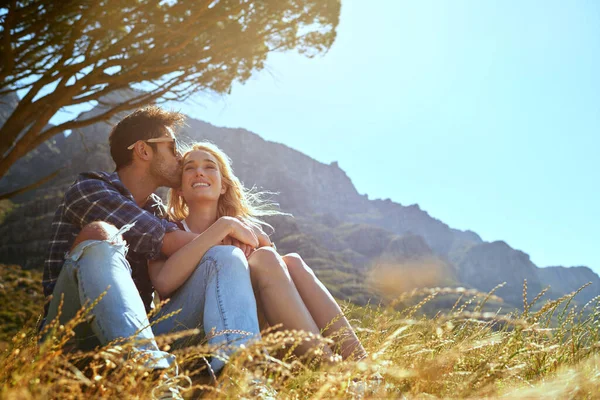Caring and carefree. Shot of an affectionate young couple enjoying a day outdoors. — Stock Photo, Image