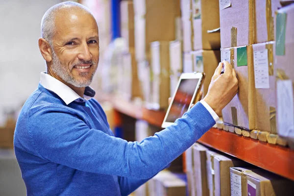 Rest assured your order is well taken care of. Portrait of a mature man working inside in a distribution warehouse. — Stock Photo, Image