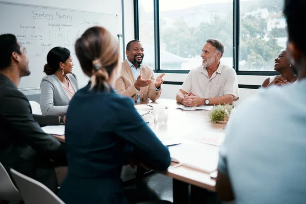 I must say Im very pleased with our work. Shot of a group of businesspeople listening to a colleagues ideas during a meeting. —  Fotos de Stock