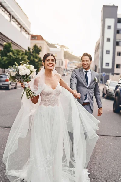 Im taking this one home. Shot of a beautiful couple out in the city on their wedding day. — Photo