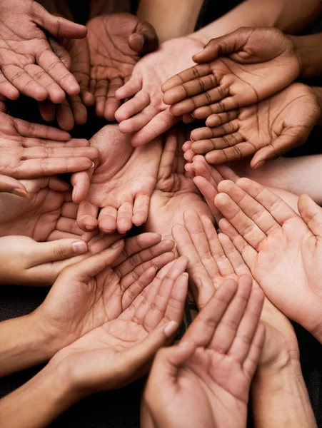 We need your support. Shot of a group of hands held cupped out together. — ストック写真