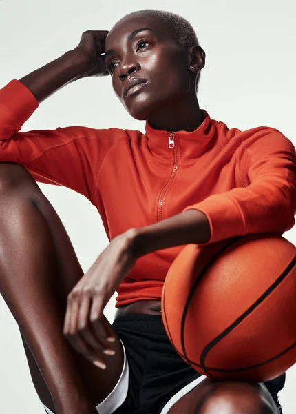 Life without basketball I dont want to know about it. Studio shot of an attractive young woman playing basketball against a grey background. — Photo