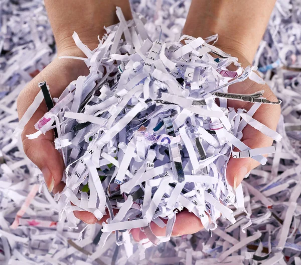 This is the only evidence thats left. Studio shot of a womans hands holding a pile of shredded paper. — Stock Photo, Image
