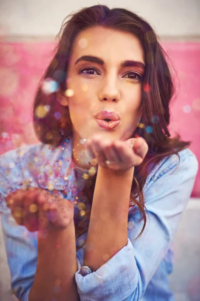 Légy az a csillogás, amit látni akarsz. Egy gyönyörű fiatal nő portréja, aki konfettit fúj odakint.. — Stock Fotó