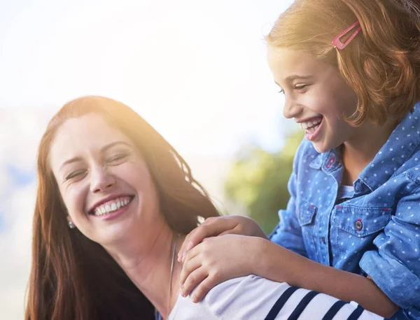 They have the most fun when theyre together. Shot of a mother giving her daughter a piggyback ride. — Stock Photo, Image