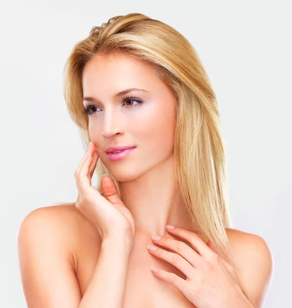 This feels amazing. Naturally beautiful blonde woman with flawless skin gazing away dreamily, isolated on white. — Stock Photo, Image