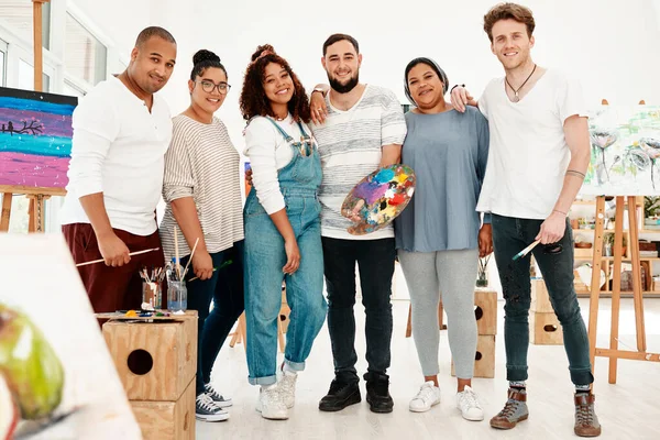 With friends like these, who needs anything else. Full length shot of a diverse group of artists standing together during an art class in the studio.