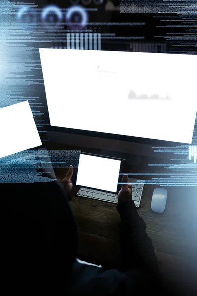 Helping himself to all your data. High angle shot of a hacker cracking a computer code in the dark. — ストック写真