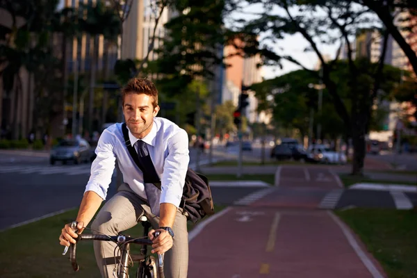 No gym membership needed. Shot of a businessman commuting to work with his bicycle. — стоковое фото