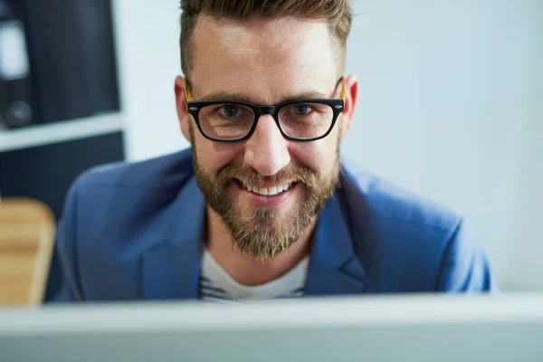 Success will soon be mine. Portrait of a young businessman working on a computer in an office. — Foto de Stock