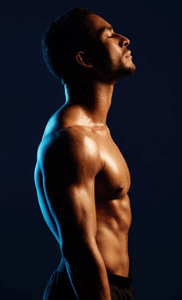 Strengthen your mind, strengthen your body. Studio shot of a fit young man posing against a black background. — 스톡 사진