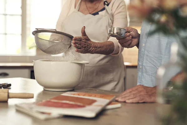 I always have help by my side. Shot of an unrecognizable couple baking together at home. — Stock Photo, Image