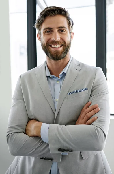 I intend to rise to the top. Portrait of a confident young businessman standing with his arms crossed in his office. — Stock Photo, Image