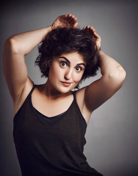 Here I come.... Studio portrait of an attractive young woman making a funny face with her hands against a grey background. — Stock Photo, Image