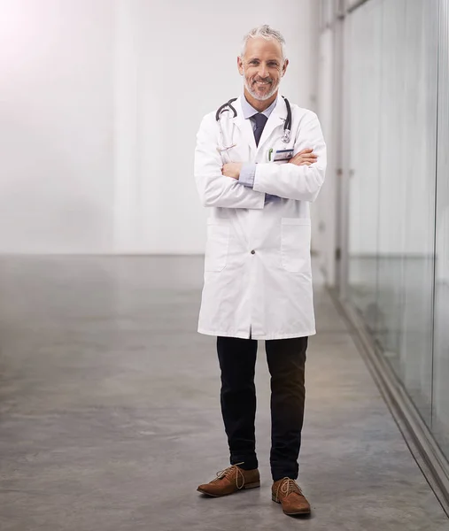 Fidati della tua salute. Ritratto completo di un medico maturo in piedi con le braccia incrociate nel corridoio dell'ospedale. — Foto Stock