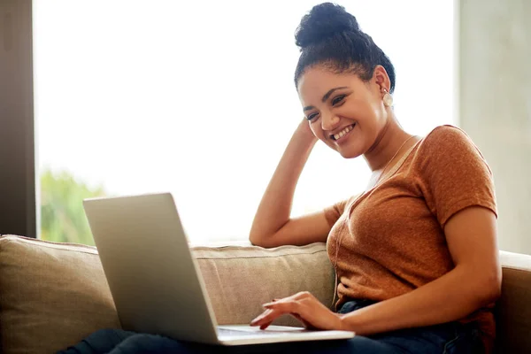 Smile though your wifi is down, it will come back. Shot of a beautiful young woman using a laptop at home. — 스톡 사진