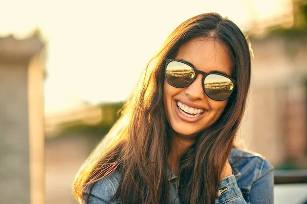 Sun is out, sunglasses on, ready to have fun. Portrait of an attractive young woman spending the day outside on a rooftop. — Stock Photo, Image