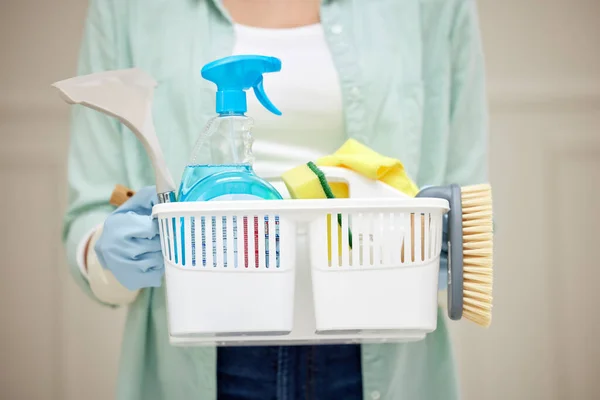 With these Im unstoppable. Shot of a woman holding a basket of cleaning products. — Foto de Stock