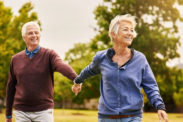 爱情使婚姻得以延续。拍了一对快乐的老夫妇去公园散步. — 图库照片