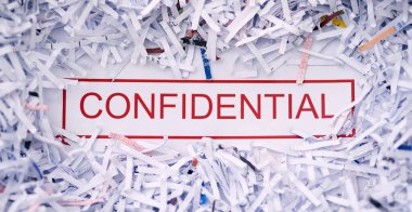 Keep it confidential. Studio shot of the word CONFIDENTIAL surrounded by shredded paper. clipart