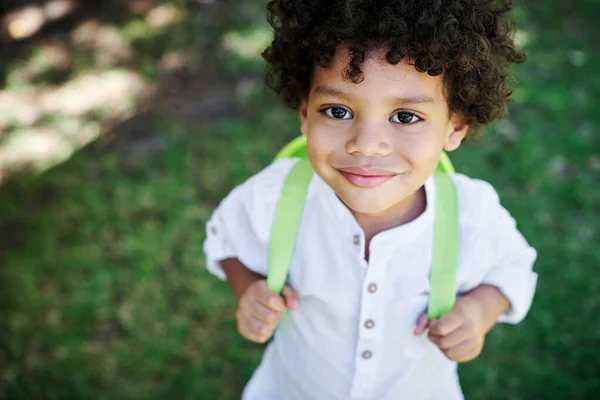 Im ready. Shot of a little boy wearing a backpack in nature. — 스톡 사진