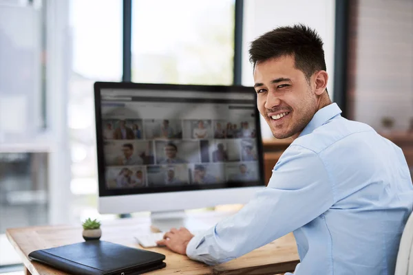 Nothing gives me greater satisfaction than my career. Portrait of a happy businessman using a computer at his work desk. — ストック写真