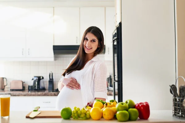 There is no health like a Mom-to-bes health. Shot of a young pregnant woman at home. — Foto de Stock