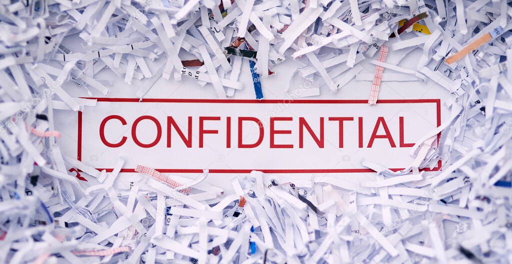 Keep it confidential. Studio shot of the word CONFIDENTIAL surrounded by shredded paper.