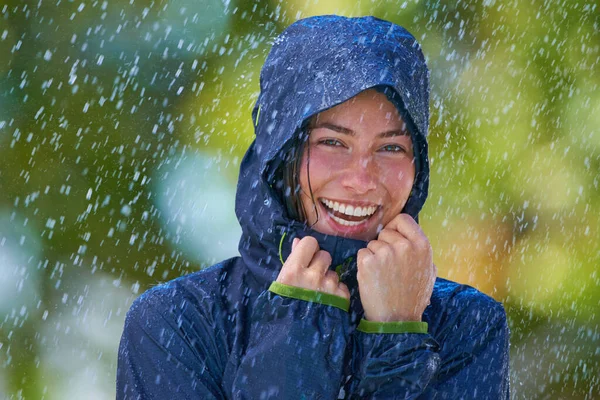 Adora la pioggia. Ritagliato colpo di una giovane donna in piedi felicemente sotto la pioggia. — Foto Stock