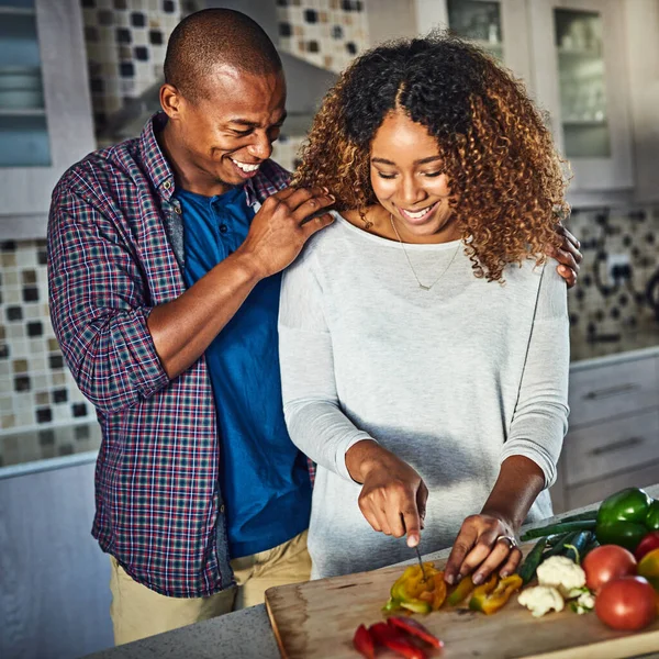 I cant wait to taste it. Cropped shot of an attractive young woman cooking at home while her husband keeps her company. — 스톡 사진