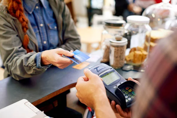 Pagamento facilitado. Tiro de um cliente pagando por sua ordem com uma máquina de cartão de crédito em um café. — Fotografia de Stock