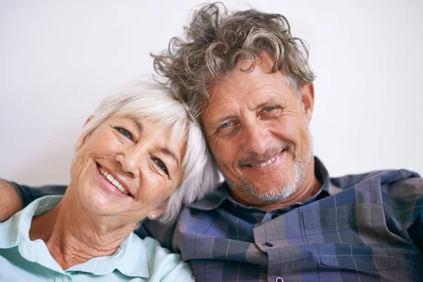 Still very much in love. Portrait of an affectionate senior couple sitting together. — Stock Photo, Image