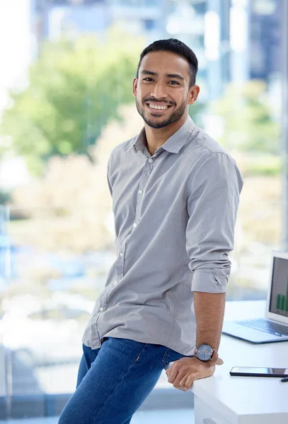 Let no one discourage your ambitions. Portrait of a confident young businessman standing in an office. — Photo