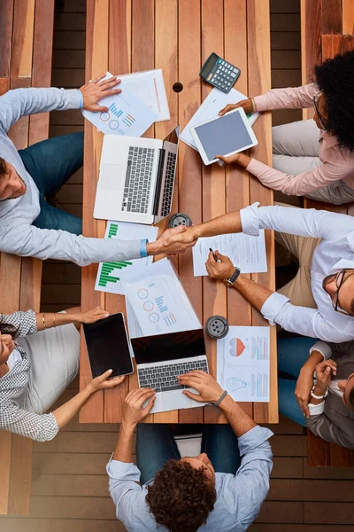 Its always a plus to introduce new talent to the team. High angle shot of businesspeople shaking hands during a meeting outdoors. — 스톡 사진