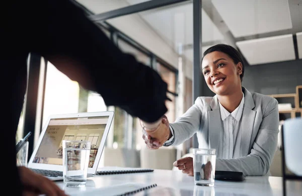 This is the start of a successful and fruitful partnership. Cropped shot of an attractive young businesswoman shaking hands with a colleague inside an office. — Stock Photo, Image