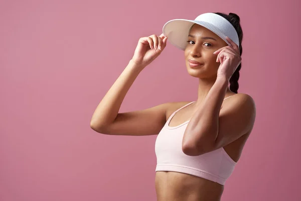 Im about to crush this workout. Cropped portrait of an attractive and sporty young woman posing in studio against a pink background. — Photo