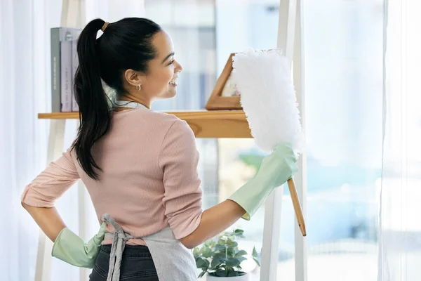 I love a fresh and clean house. Shot of a woman holding a duster while doing chores at home. — Stock Photo, Image