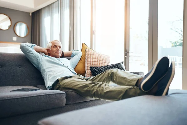 En la zona de casa. Tiro de un hombre mayor relajándose en el sofá en casa. —  Fotos de Stock