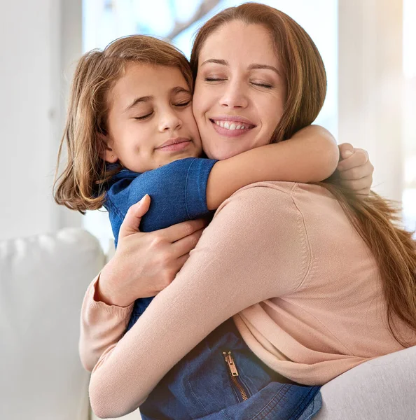 Priorities. Shot of a young mother and her daughter at home. — Stock Photo, Image