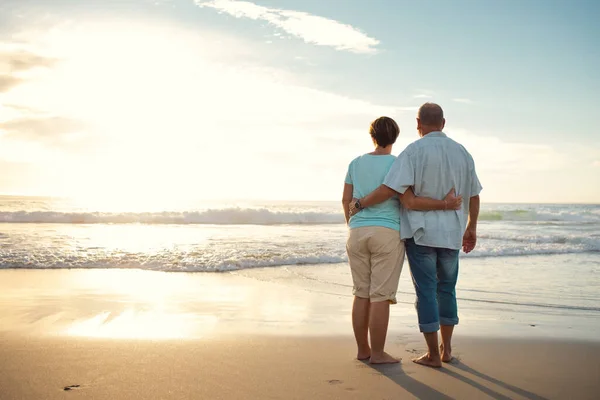 Life is full of beauty. Notice it. Rearview shot of a couple admiring the view while at the beach. — Stock Photo, Image