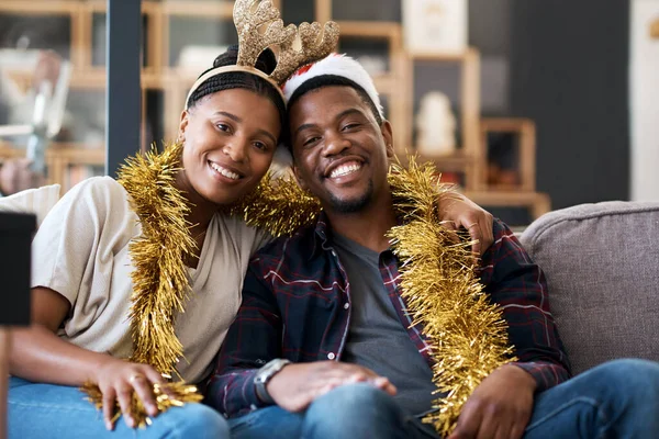 You can just feel the love and joy in the air. Portrait of a young couple celebrating Christmas at home. —  Fotos de Stock