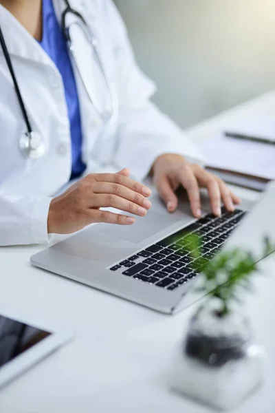 In charge of her medical practice. Closeup shot of a doctor working on a laptop in an office. — 스톡 사진