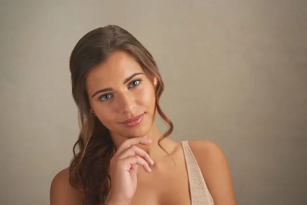 Let them fall in love with the real you. Studio shot of an attractive young woman posing against a brown background. — Photo